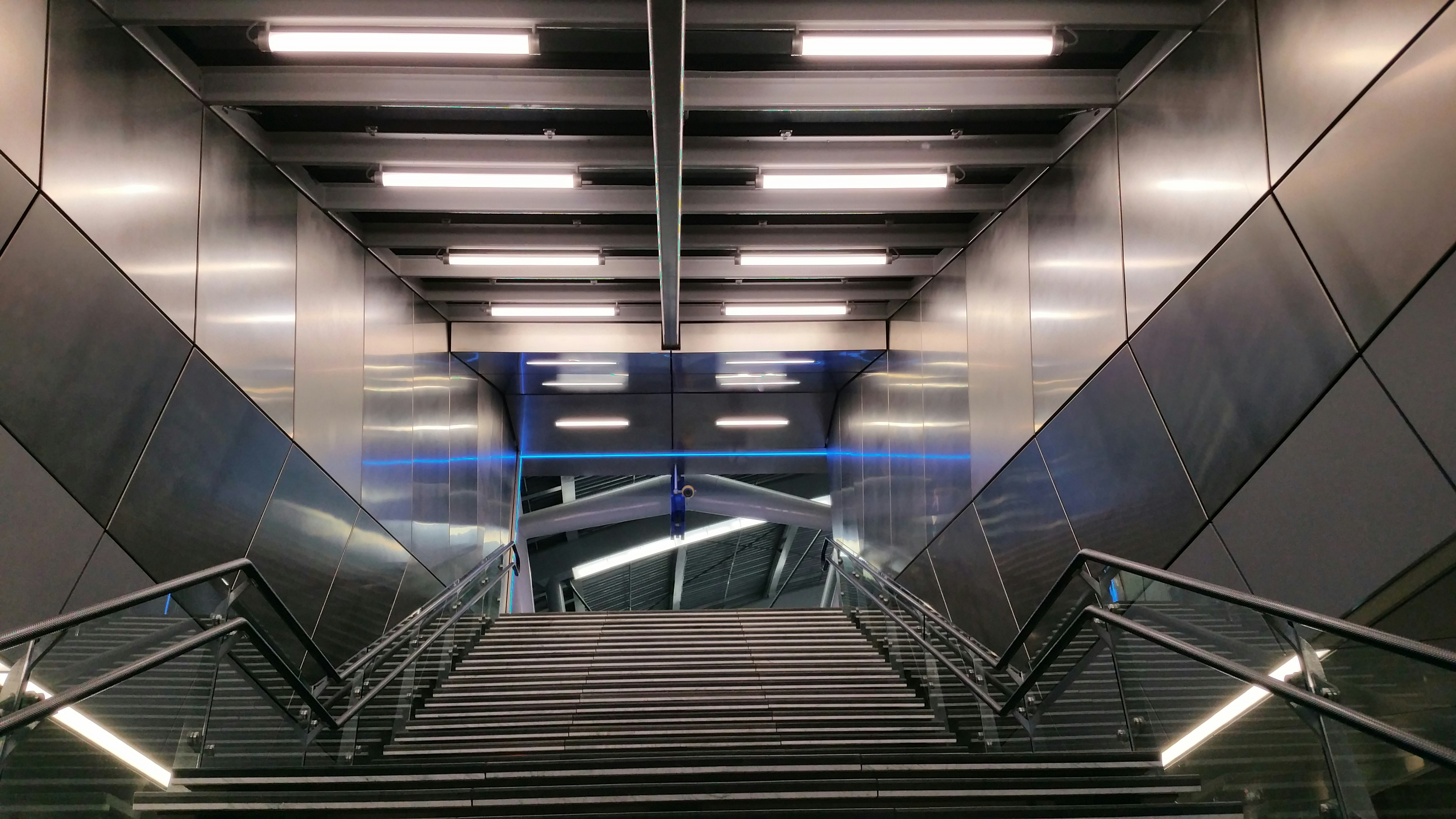 black and white staircase with stainless steel railings